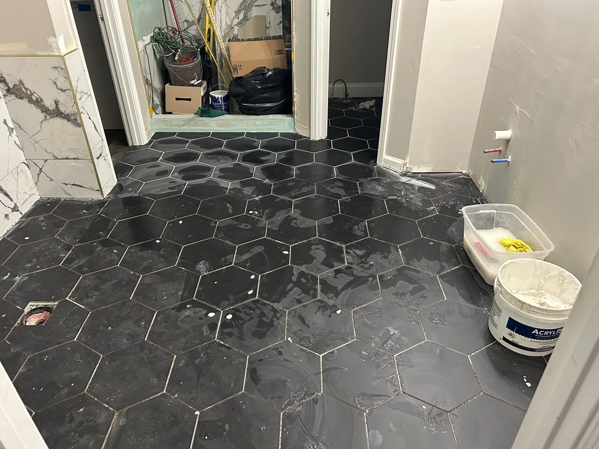 Black hex floor tile freshly grouted and sealed