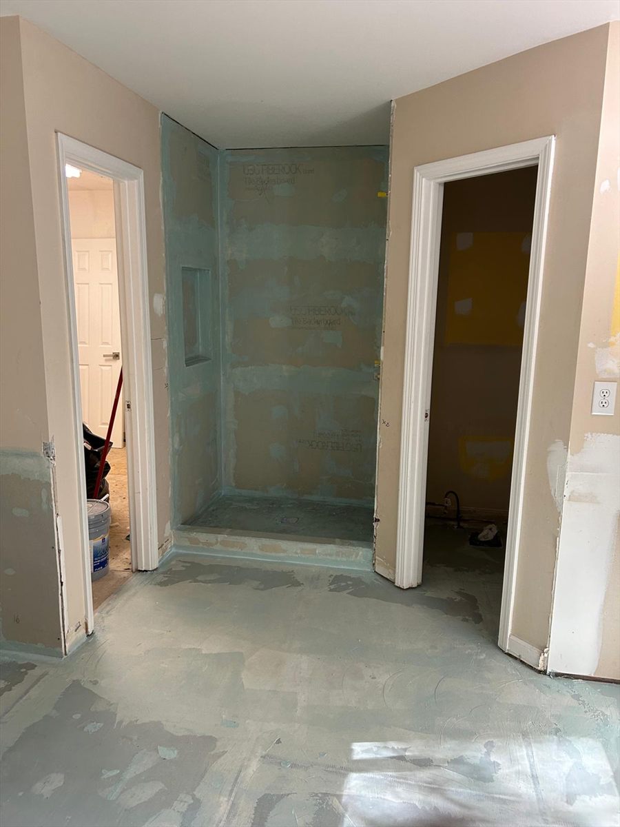 Before: the shower stall waterproofed and backed, ready for tile