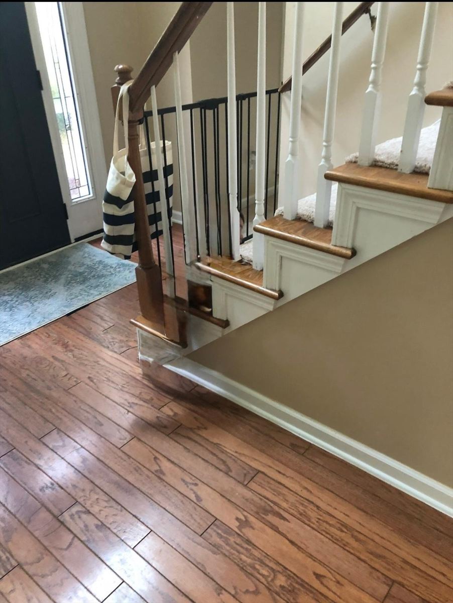 Before: oak handrail, turned spindles and carpeted treads