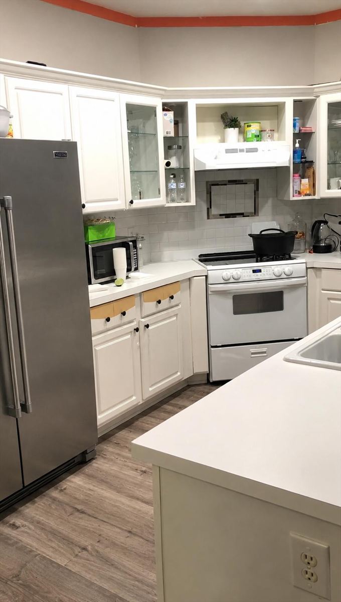 Before: dated cabinets, laminate counters and a painted accent stripe